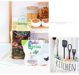 Colorful metal binder clips being used as food sealers and apron clips in a kitchen