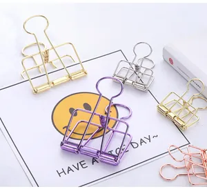 Close-up of assorted colorful hollow metal binder clips in gold and rose gold