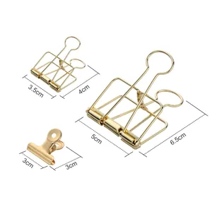 Set of gold hollow binder clips and spring clamp in various sizes for office use