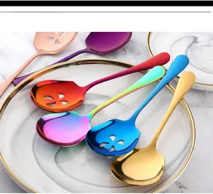Macro shot of colorful stainless steel serving spoons with unique flower cutouts