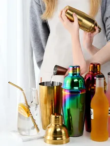 Detail view of colorful stainless steel cocktail shakers in gold and aurora finish