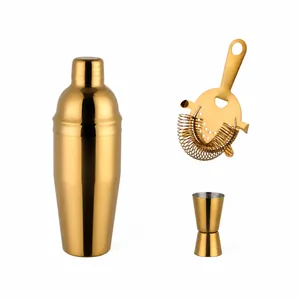 Golden stainless steel cocktail shaker set with Hawthorne strainer and double jigger