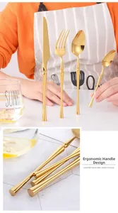 Detailed close-up of golden stainless steel cutlery with slim cylindrical handle design