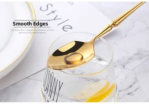 Macro shot of smooth polished edges on a golden bamboo handle stainless steel spoon