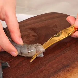 Golden stainless steel shrimp deveiner tool with curved blade for peeling and cleaning