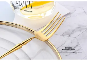 Detail of polished golden stainless steel fork with rounded tines for dining