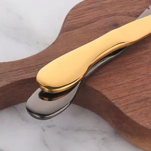Golden and gunmetal grey stainless steel shrimp knives with polished mirror finish handles