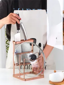 Macro view of rose gold stainless steel knife holder and pot lid rack for kitchen