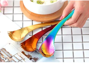 Macro view of curved stainless steel spork with colorful mirror polished finish