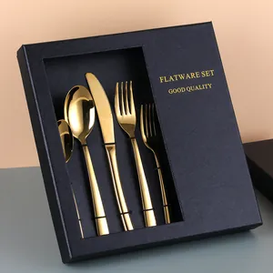 Detail of gold plated stainless steel cutlery set inside a premium black textured gift box
