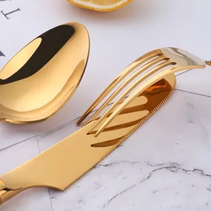 Modern gold 304 stainless steel cutlery set with mirror finish on marble surface