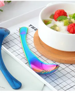 Macro detail of ergonomic curved stainless steel spoons with a vibrant rainbow mirror finish