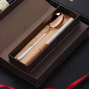Rose gold cutlery set with spoon and chopsticks in a luxury brown gift box with gold silk lining