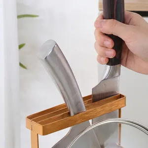 Golden stainless steel kitchen rack for knives and pot lids on a clean countertop