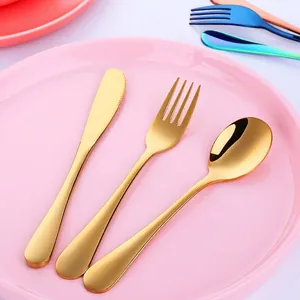 Golden 304 stainless steel kids cutlery set with knife fork and spoon on pink plate