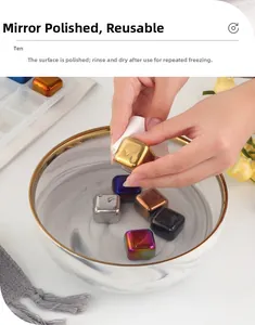 Detail of hand wiping a mirror-polished golden stainless steel ice cube with storage box