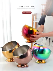 Macro shot of slanted stainless steel seasoning bowls in gold, rose gold and rainbow colors
