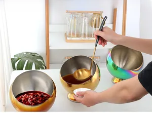 Polished stainless steel slanted spice jars in gold and rainbow finishes with long spoons