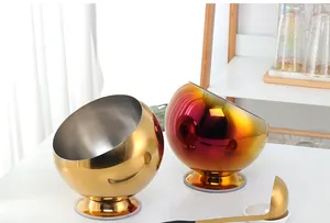 Polished stainless steel spherical seasoning bowls with suction base and golden spoon