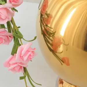 Spherical stainless steel seasoning jar with a golden mirror finish and floral reflection