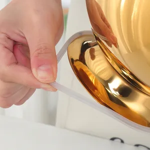 Golden stainless steel bowl featuring a non-slip silicone base with high-mirror finish