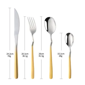 Detailed view of silver and gold stainless steel cutlery set with wave-shaped handles