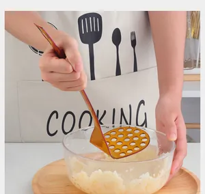 Manual rose gold stainless steel potato masher with ergonomic handle and round holes