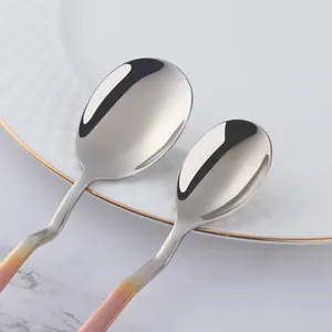 Detail of pink gradient handle spoons with mirror-polished stainless steel finish