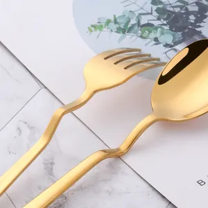 Golden stainless steel cutlery set with unique wavy handles and mirror polished finish