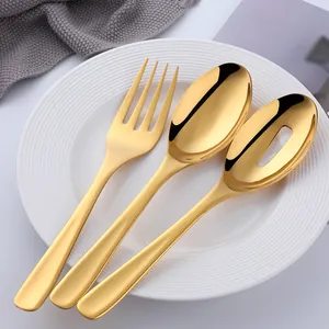 Detail of gold plated stainless steel serving set with mirror polished finish on plate