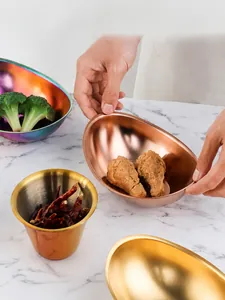 Macro shot of colorful stainless steel dipping bowls with a polished metallic finish