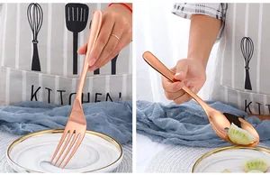 Macro detail of rose gold stainless steel serving spoon and fork with polished finish