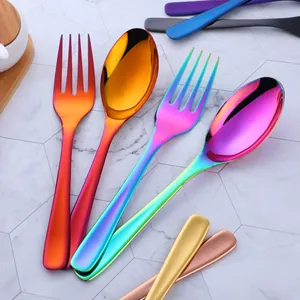 Macro view of iridescent rainbow titanium-plated stainless steel serving spoon and fork set