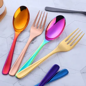 Detailed close-up of rainbow and gold titanium plated stainless steel spoons and forks