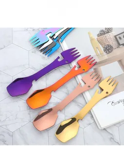 Close-up of colorful multifunctional stainless steel camping cutlery on a marble background