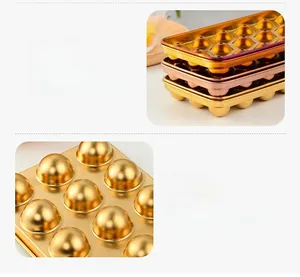 Close-up of stackable gold stainless steel ice ball mold with a deep spherical design