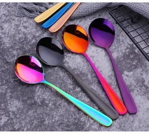 Close-up of colorful round stainless steel spoons in vacuum-plated mirror finish