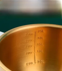 Close-up of internal capacity markings in 2500ml gold stainless steel mixing bowl