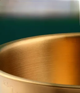 Macro shot of 304 stainless steel bowl showing golden brushed texture and frosted process