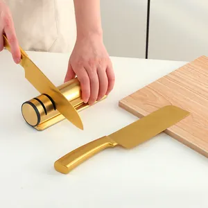 Detailed view of golden 3-stage knife sharpener with matching gold stainless steel knives