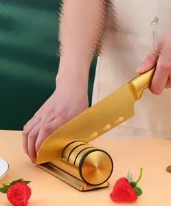 Manual three-stage gold knife sharpener with cylindrical handle used on kitchen blade