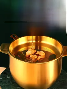 Golden stainless steel oil filter pot pouring hot oil through mesh strainer on marble base