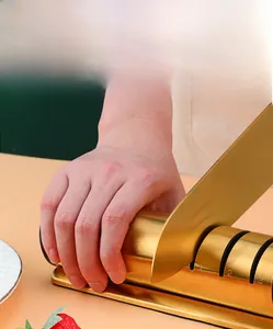 Close-up of golden three-stage knife sharpener with ergonomic handle and anti-slip base