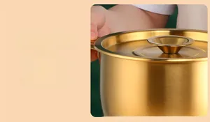 Detailed view of golden 304 stainless steel oil pot with a well-fitting lid and handle