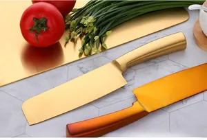 Macro view of golden brushed stainless steel chef knife and ultra-thin metal cutting board