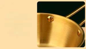 Detail of reinforced double rivets on golden stainless steel bowl with brushed texture
