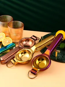 Macro detail of various stainless steel lemon squeezers with hanging rings and long handles