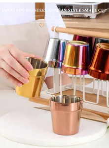 Close-up of 304 stainless steel golden cups with interior material stamp and smooth finish