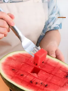 Close-up of dual-head stainless steel watermelon slicer cutter and fork tool in use