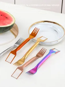 Detail of multi-color stainless steel watermelon slicer forks on marble background